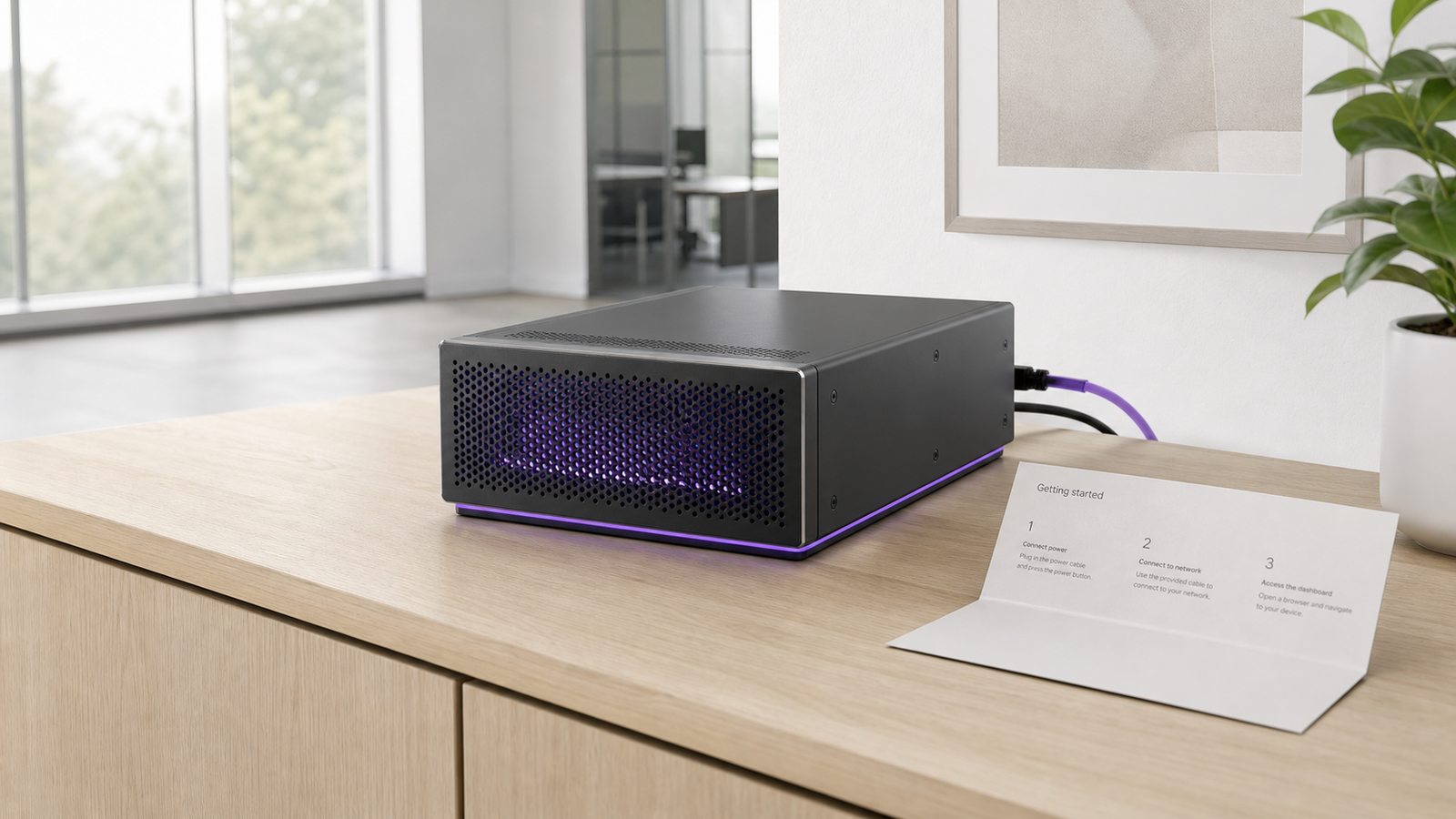 A local AI server set up on a credenza with its power and network cables neatly dressed, next to a printed getting-started card